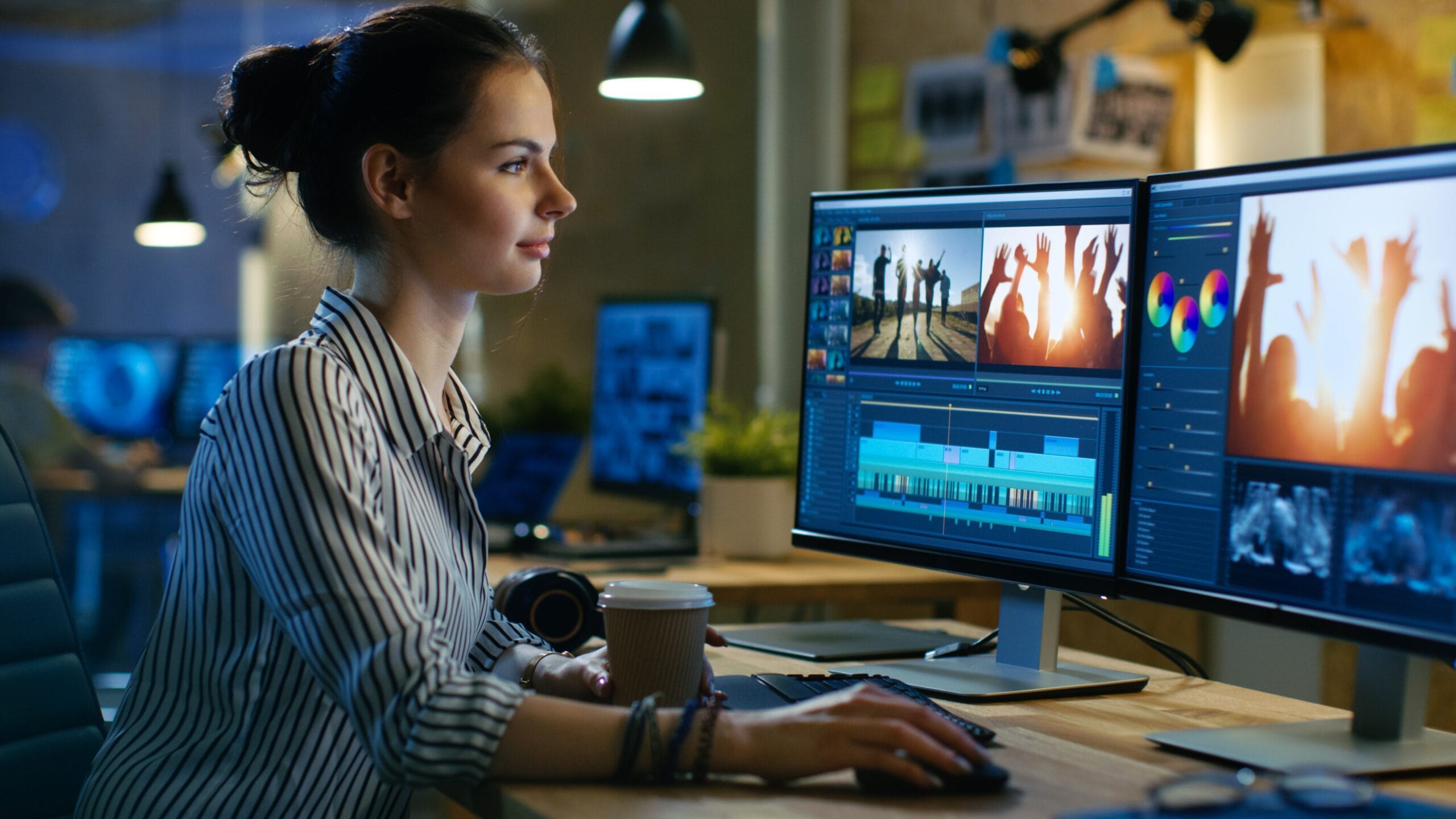 Virtual admin assistance services — A video editor sitting in front of two computer screens, editing a video production as a virtual admin assistant service provider.